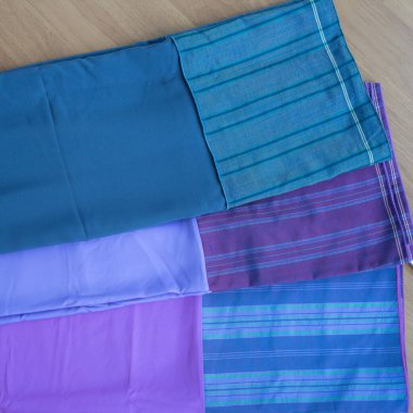 multi-colored pillowcases on background, close up