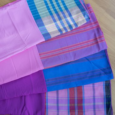 multi-colored pillowcases on background, close up