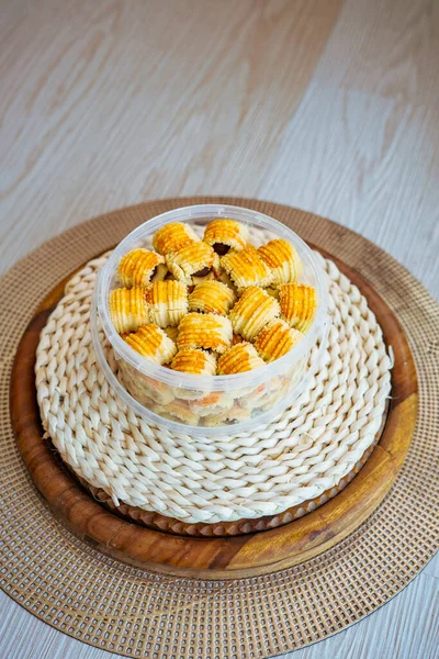 Traditional pineapple jam tart roll cookies or a malay called tart nanas in a plastic container.