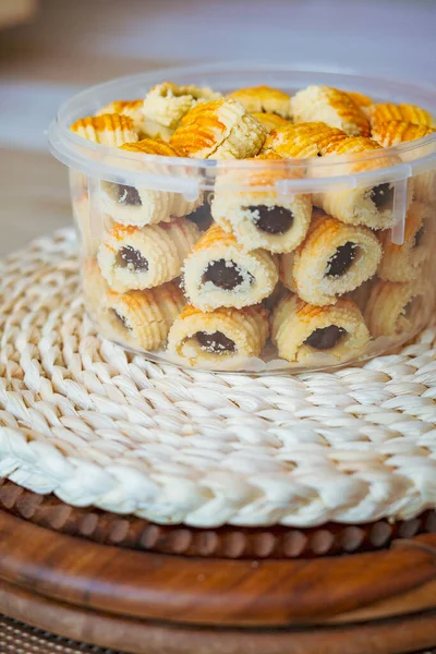 Traditional pineapple jam tart roll cookies or a malay called tart nanas in a plastic container.