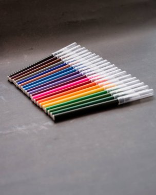 Koyu arkaplanda renkli işaretler var. Eğitim, öğrenim, yaratıcılık, sanat ve zanaat kavramı.