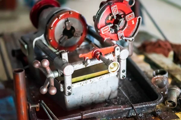 threading machine for iron pipes in a construction site.