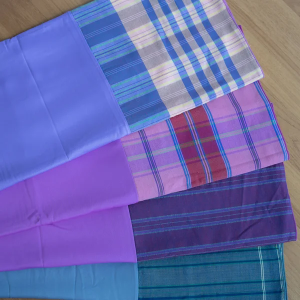 multi-colored pillowcases on background, close up