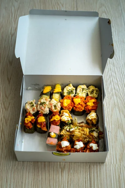 Various sushi in a take away box container.