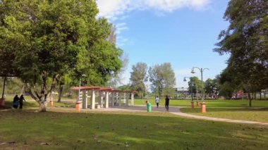 Bangi, Malezya - Mart 2021 Taman Tasik Cempaka 'da yürüyüş ve egzersiz yapan insanlar. Görüntü düşük ışıktan dolayı gürültü içerebilir.