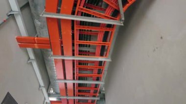 Tavanda çelik elektrik kablosu kutusunun düşük açılı görüntüsü asılı. Yavaş çekim.