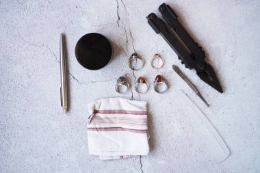 Şık erkek yüzükleri, kalem, aletler, mendil, poz ve tımar için parfüm. Beton arka planda metroseksüel sezaryenler. Şehir kompozisyonu. Üst görünüm.