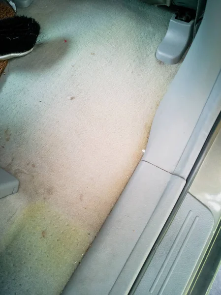 Dirty Beige car mat in the interior of a Korean suv. a car service after dry cleaning.