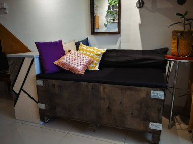 Kuala Lumpur, Malezya - 8 Haziran 2019: Büyük kargo ahşap sandığı bir apartman dairesindeki endüstriyel iç tasarımı eşleştirmek için kanepeye yerleştirildi.