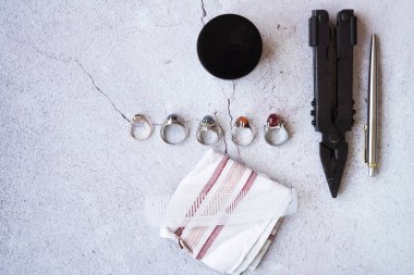 Şık erkek yüzükleri, kalem, aletler, mendil, poz ve tımar için parfüm. Beton arka planda metroseksüel sezaryenler. Şehir kompozisyonu. Üst görünüm.