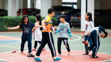 Bangi, Malezya - 10 Temmuz 2019: Çocuklar beyzbol sahasında mutlu bir şekilde oynuyorlar. Toplum çocukları birlikte oynuyorlar..