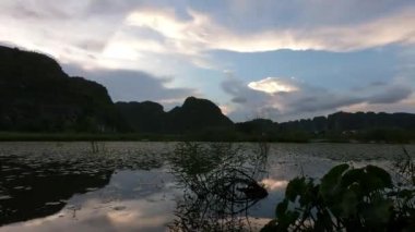 Limestone mountains sunset in Ninh Binh, Vietnam by the lake. Beautiful view. Time lapse
