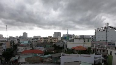 Low clouds time lapse, skyscraper on background. Ho Chi Minh, Vietnam