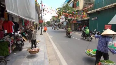 Walking in a traditional old quarter in the center of Hanoi, Vietnam
