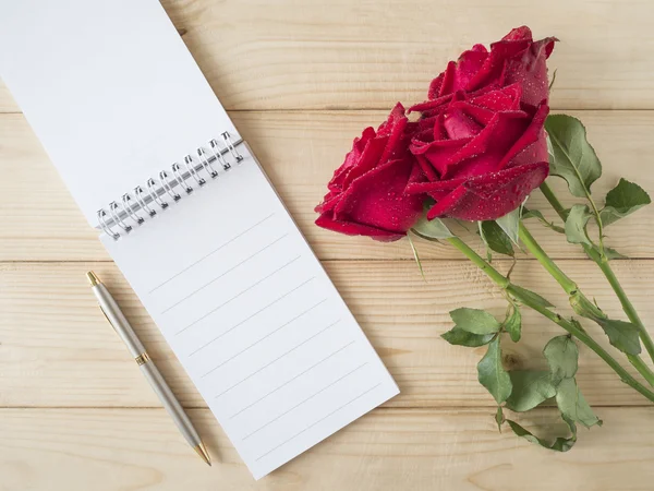 Red rose and notebook 1 — Stock Photo, Image