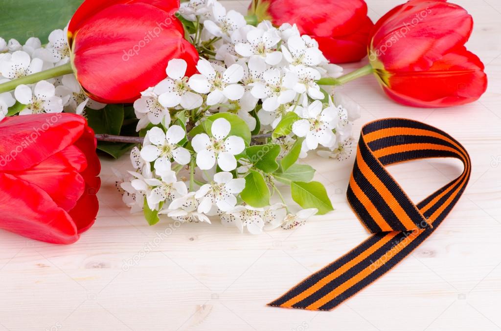 flowering cherry branch with tulips and St. George ribbon