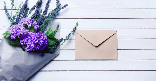 Envelope and wildflowers — Stock Photo, Image