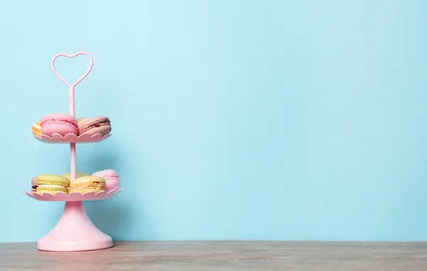 Colorful macarons on blue — Stock Photo, Image