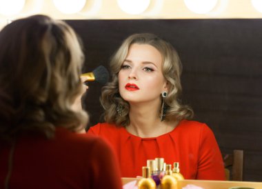 Blond woman near a mirror