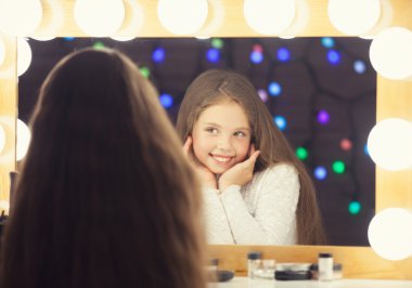 Young girl near a mirror.