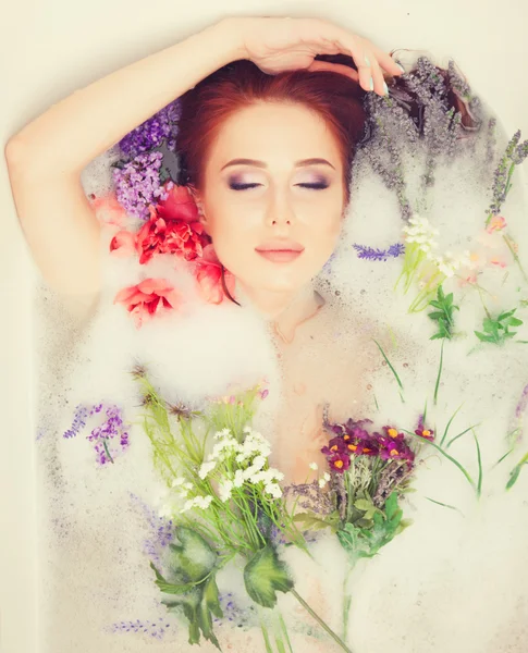Девушка в ванной комнате с цветами — стоковое фото