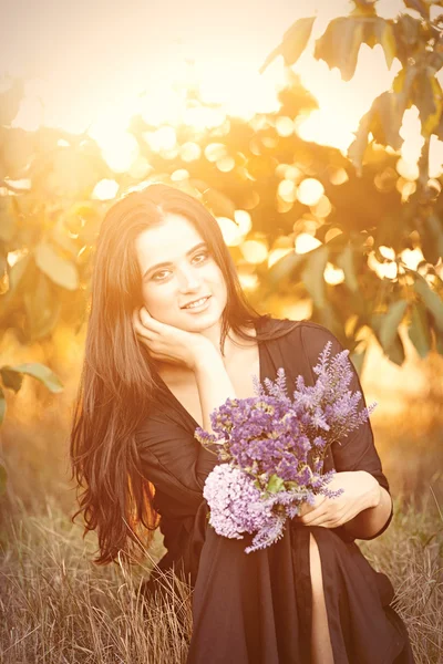 Fille avec des fleurs à la campagne — Photo