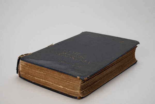 Jakarta, Indonesia-August 2, 2021: Pile of old books isolated white background