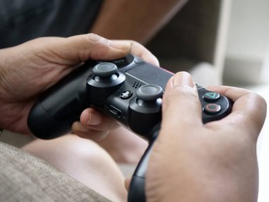 Hands Holding a Video Game Controller, 4 Ocak 2026, Jakarta, Endonezya