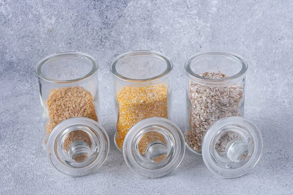 Glass Jars Different Types Cereals Grey Background — Stock Photo, Image