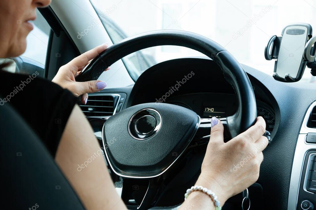 middle aged woman driving a car selective focus
