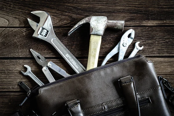 tools in leather bag - labor day and business fight background c