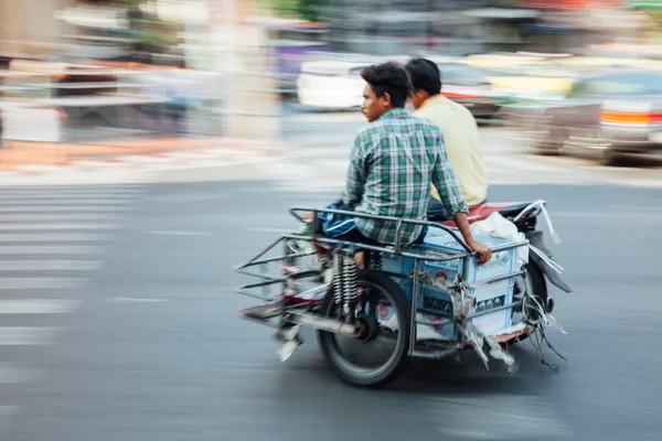 Panning of men sitting in sidecar of motorcycle — Stock Photo, Image