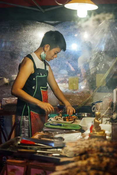 Mujer joven cocina pescado y mariscos —  Fotos de Stock