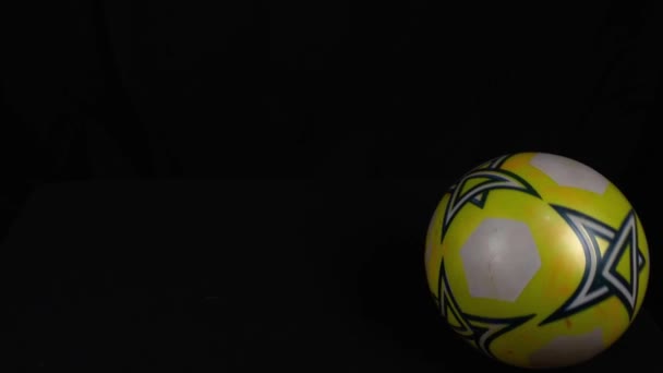 Spinning Plastic Soccer Ball in Front of Black Background — Stock Video