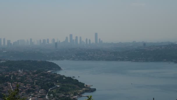 Seascape, Bosphorus is seen between skycrapers and green hills in silhoulette — Stock Video