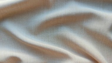 Dalgalar ve noktalar kapalı bej kumaş arkaplan, ilginç dalgalı arkaplan, kumaş üzerinde üst görünüm dalgaları, yumuşak kırışık matte kumaş, gölge kumaş 