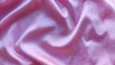 Pembe kumaş arka plan, dalgalar ve noktalar kapalı, ilginç dalgalı arkaplan, kumaş üzerindeki dalgaların üst görünümü, yumuşak kırışık mat kumaş, gölge kumaş 