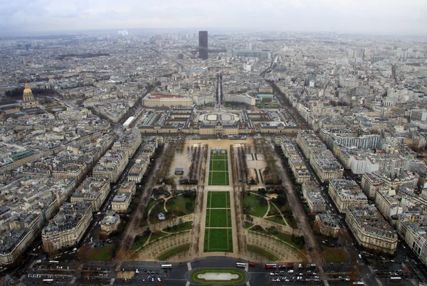 View southeast from the top level of the Eiffel Tower, down the Champ de Mars, with the Tour Montparnasse in rainy day, Paris, France — стокове фото