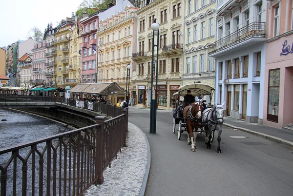 KARLOVY VARY, CZECH REPUBLIC - APRIL 27, 2013: Horse carriage on the street of Karlovy Vary or Carlsbad that is a spa town situated in western Bohemia, Czech Republic — ストック写真