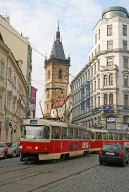 PRAGUE, CZECH REPUBLIC - APRIL 16, 2010: Nove Mesto or New Town of Prague. Tower of New Town Hall and a city tram.