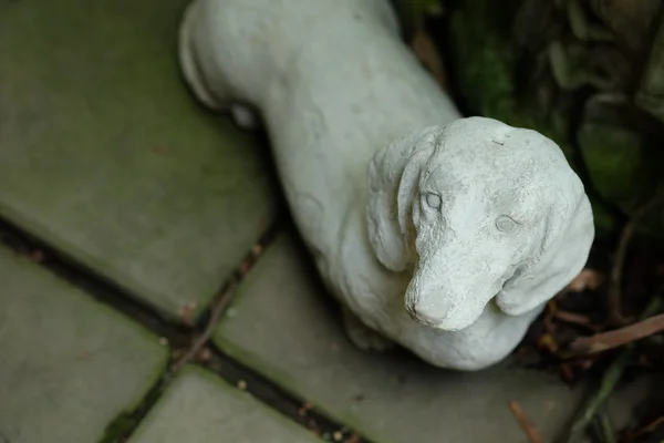 Cement statues Dog on the floor. Royalty Free Stock Images