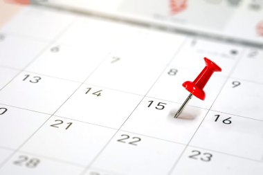 Embroidered red pins on a calendar  clipart