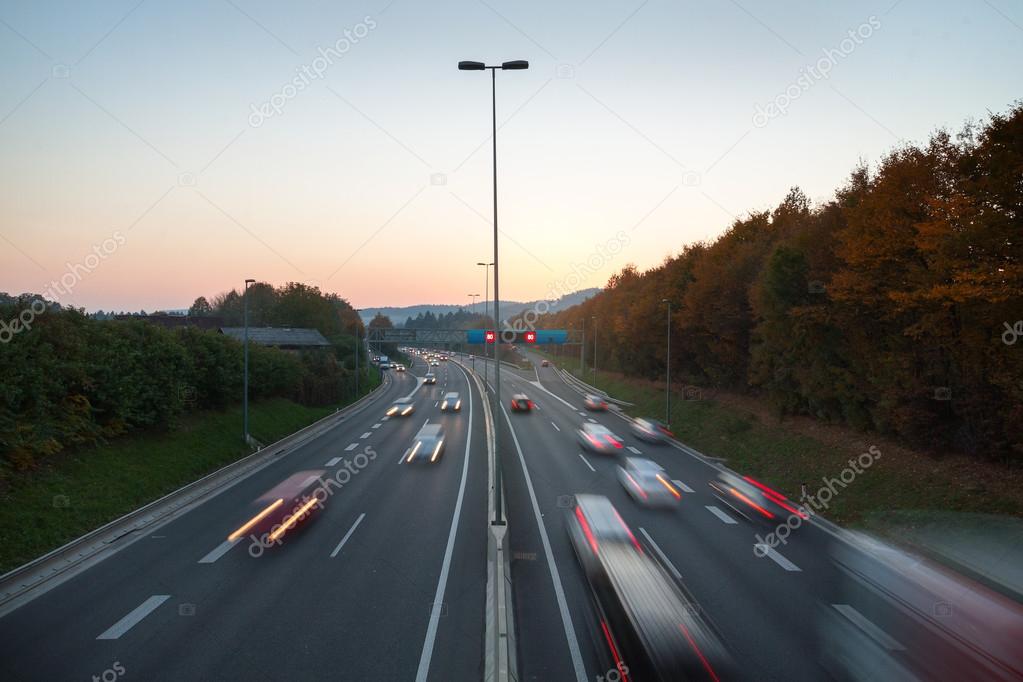 Traffic at sunset on highway
