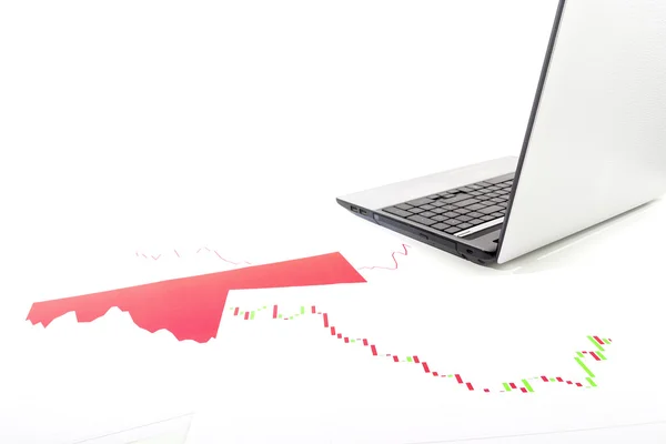 Down trend trading charts and laptop