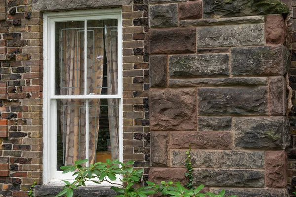 Kahverengi bloklar duvarındaki beyaz pencereye bak