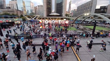 Toronto, Kanada - 19 Ekim 2025: Toronto Waterfront maratonu sırasında koşucular ve izleyicilerle birlikte Nathan Phillips Meydanı 'nın sabah manzarası. 