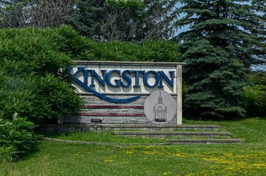 Kingston, ON, Canada - September 18, 2025: A welcome sign for the city of Kingston is visible from a highway on a cloudy day.