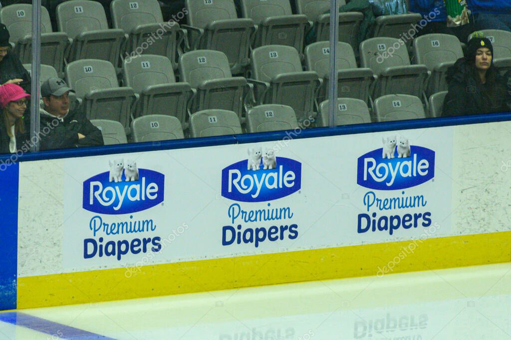 Toronto, ON, Canada - September 19, 2025: A Royale logo is visible on the boards of a hockey rink during a game, with spectators watching from the stands.
