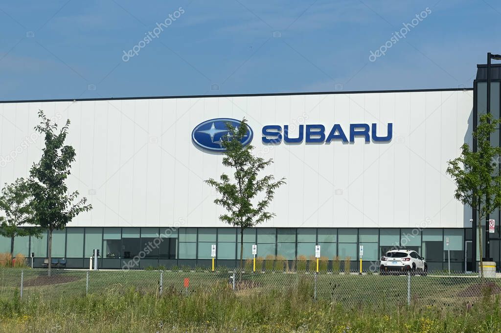 Toronto, ON, Canada - August 15, 2025: A large, modern Subaru corporate building is visible on a sunny day with green trees and a field in front of the building.