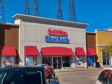 Toronto, ON, Kanada - 19 Eylül 2025: Güneşli bir günde kırmızı tenteli ve binanın önünde park yeri olan SoftMoc Shoe Rack mağazası.